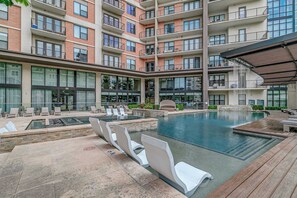 A modern building with a rooftop pool area, multiple balconies, and a covered seating area. - Luxury 3BR Penthouse |Skyline Views |Uptown Dallas (Dallas)