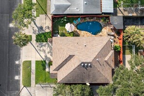 Ein Wohnhaus mit Swimmingpool, überdachter Terrasse und einem umzäunten Garten.