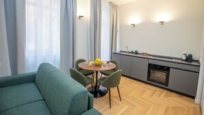 Una cocina moderna con comedor, que incluye una mesa redonda, sillas y un sofá.