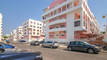 A multi-story residential building with balconies and a pedestrian staircase.