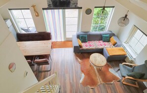 A spacious living area with a sofa, a round coffee table, and a leather rug. - Luxury vacation home in Lunteren, in the Veluwe region (Lunteren)