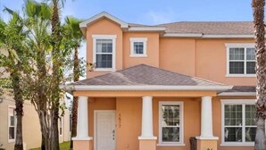 A two-story house with a front porch, a door, and windows. - Screened Private Pool Home, 3BR, Steps from Hidden Forest Fun (Clermont)