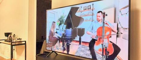 A television mounted on a wall with a flat-screen display.