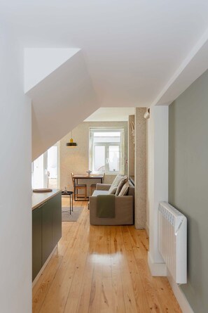 A modern interior with a kitchen, dining area, and a cozy seating space. - Liiiving in Porto - Vintage Terrace Apartment (Porto)