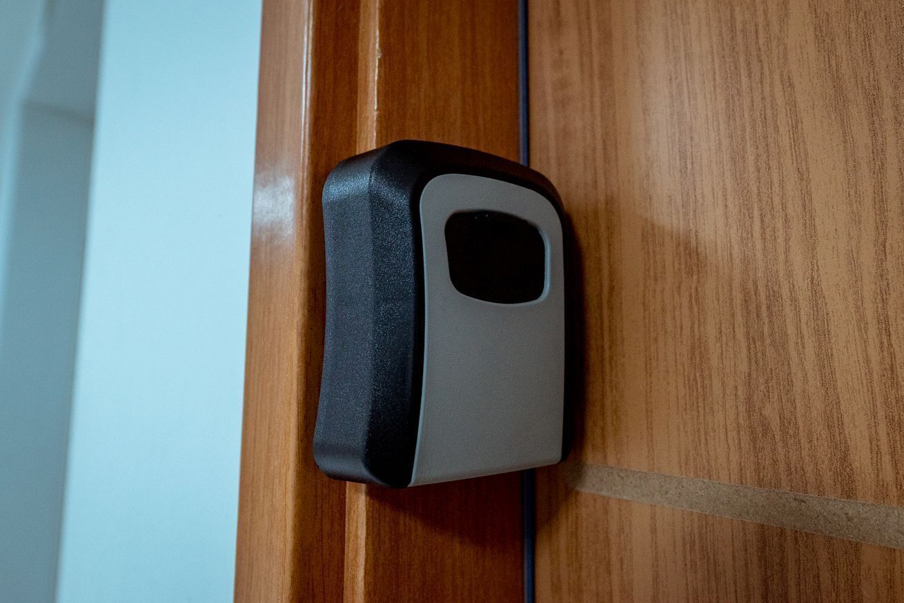 A black and gray electronic device mounted on a wooden surface.