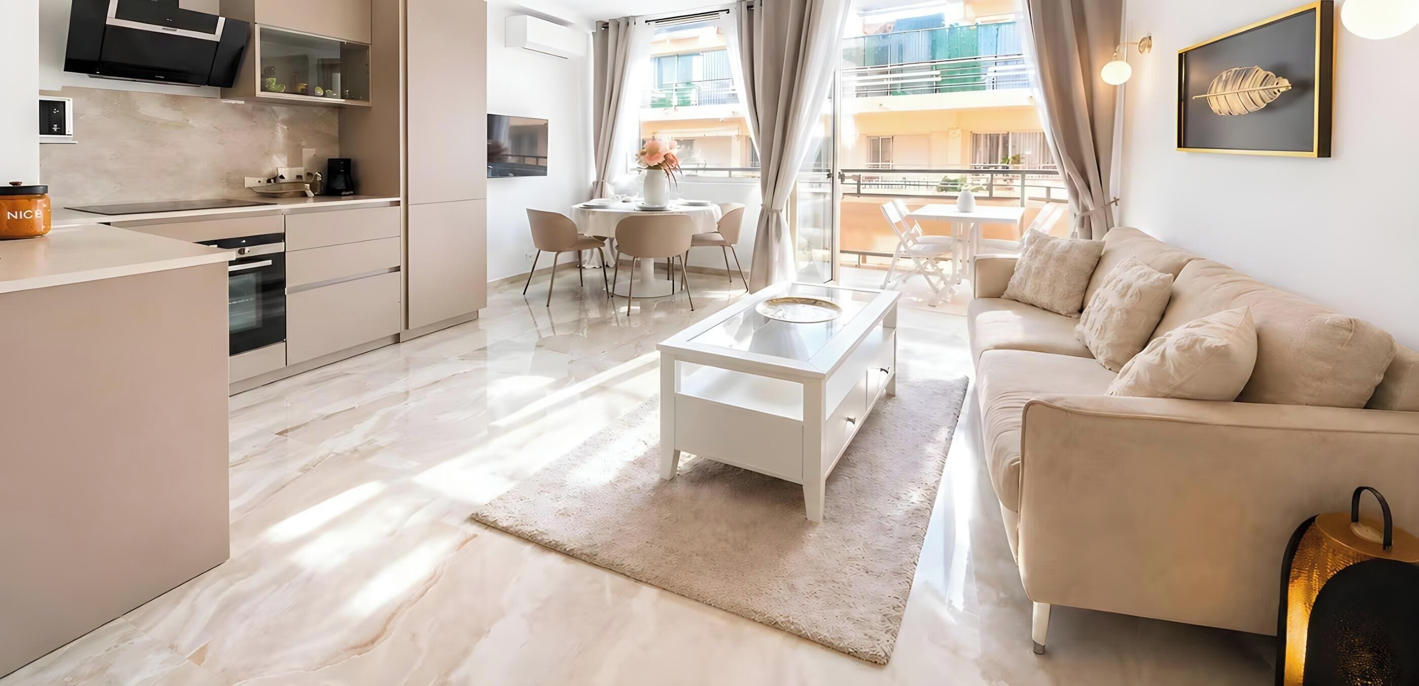 A modern living space with a kitchen, dining area, and a sofa.