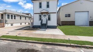 Un bâtiment à deux étages, doté d’une entrée principale, d’un garage et d’une pelouse bien entretenue.
