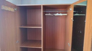 A wooden wardrobe with multiple shelves and a hanging rod. - Max House . botanical garden full room (Yerevan)