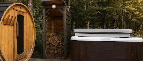 A hot tub and a sauna in a wooded area.