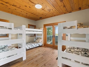 A room with bunk beds, wooden flooring, and a wooden ceiling. - Mountain High - Hot Tub, Game Room and Views (Sapphire)