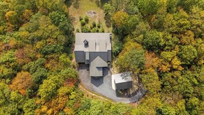 An aerial view of a house surrounded by dense forest. - Mountain High - Hot Tub, Game Room and Views (Sapphire)