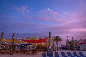 Ein Restaurant direkt am Strand mit Außenbereich und Sonnensegel.