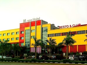 A multi-story building with a M-One Hotel and a Resto & Club. - M-one Hotel Bogor (Bogor)