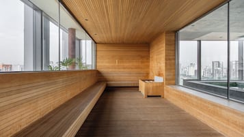 A modern interior with wooden paneling, a bench, and a small seating area.