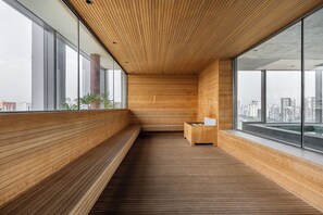 A modern interior with wooden paneling, a bench, and a small seating area. - StayHome - Moema Cyrela - Piscina & Gym (São Paulo)