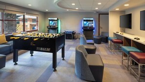 A modern room with a foosball table, two arcade machines, a flat-screen TV, and comfortable seating. - 1 Bedroom Villa Timber Lodge Resort S Lake Tahoe (South Lake Tahoe)