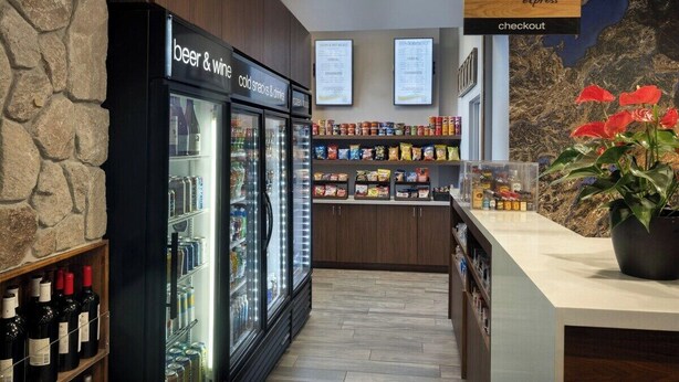 A checkout area with a sign for 'marketplace express' and a refrigerated section labeled 'beer & wine' and 'cold snacks & drinks'. - 1 Bedroom Villa Timber Lodge Resort S Lake Tahoe (South Lake Tahoe)
