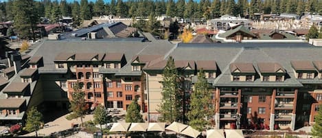 A resort with multiple buildings, a swimming pool, and a view of the mountains.