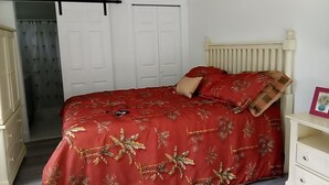 A bedroom with a bed, a wardrobe, a radiator, and a door. - Spacious 3-bedroom house in Fort Myers with pool, straight drive to the beach (Fort Myers)