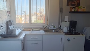 A compact kitchen with a sink, a coffee maker, and a refrigerator. - Apartment in Málaga: City, Tourism & Beach (42 meters) (Ma)