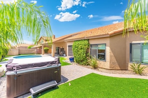 A backyard with a hot tub, a swimming pool, and a well-maintained lawn. - Desert Retreat with Pool Near Golf & Hiking (Scottsdale)