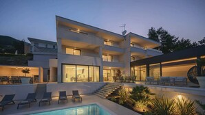 A multi-story residential building with a swimming pool, outdoor seating, and a staircase leading to the upper levels. - Villa Maremont Nearby Opatija - Crovillas (Opatija)
