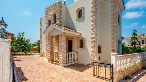 A two-story building with a stone facade, a balcony, and a tiled roof. - Villa Petra Sun-Coral Bay (PAFOS)