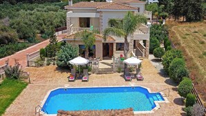 A two-story house with a swimming pool, outdoor seating, and a garden. - Villa Petra Sun-Coral Bay (PAFOS)