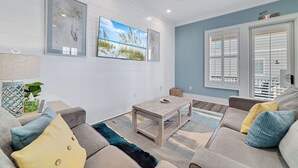 Ein Wohnzimmer mit einer Couch, einem Couchtisch und Kunstwerken an der Wand.