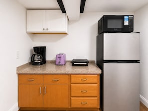 A kitchenette with a microwave, toaster, coffee maker, and a refrigerator. - Spacious Studio Near Boston--Parking--Washer/Dryer (Everett)