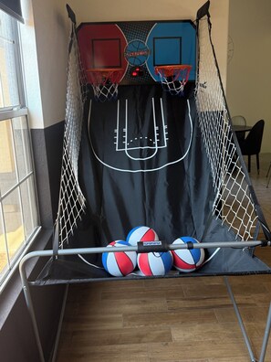 A basketball court with two hoops and a netted enclosure. - Beautiful 3-bedroom house with pool & game room in charming Glendale (Glendale)