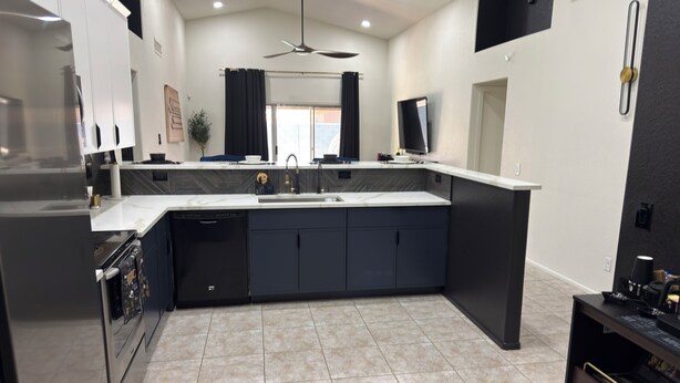 A modern kitchen with a central island, built-in appliances, and a large window. - Beautiful 3-bedroom house with pool & game room in charming Glendale (Glendale)