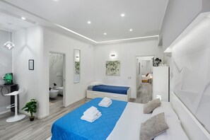 A modern bedroom with a bed, a desk, and a bathroom. - Secretum Pompeii – Queen Deluxe Room (Pompei)
