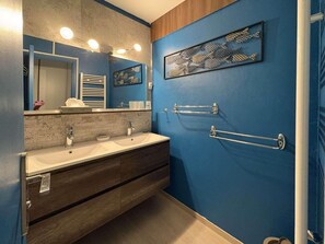 A bathroom with a double sink vanity, a towel rack, and a framed artwork on the wall. - 150m from ski slopes, 6th floor, balcony, 57m², Les Orres (Les Orres)