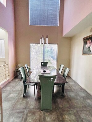 A conference room with a glass table, six chairs, a window with blinds, and a framed picture on the wall. - Elegant, Stylish & Spacious Retreat / 3BD / 2.5 BA (Los Angeles)