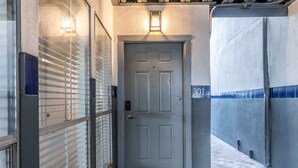 A grey door with a keypad lock, a small illuminated sign above it, and a number '301' on the wall. - Spacious Austin Retreat 3BR Pool Views (Austin)