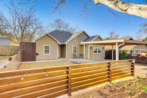 A residential property with a fenced backyard, a covered patio, and a detached garage. - Sauna, Hot Tub & Backyard Fun in OKC (Oklahoma City)