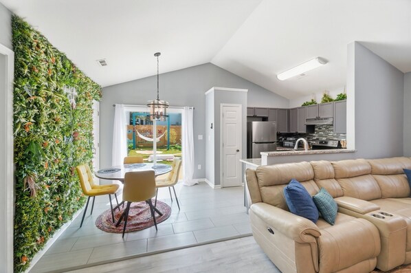 A modern kitchen with grey cabinets and a stainless steel refrigerator. - Cowboy pool Hot tub Boho Charlotte (Charlotte)