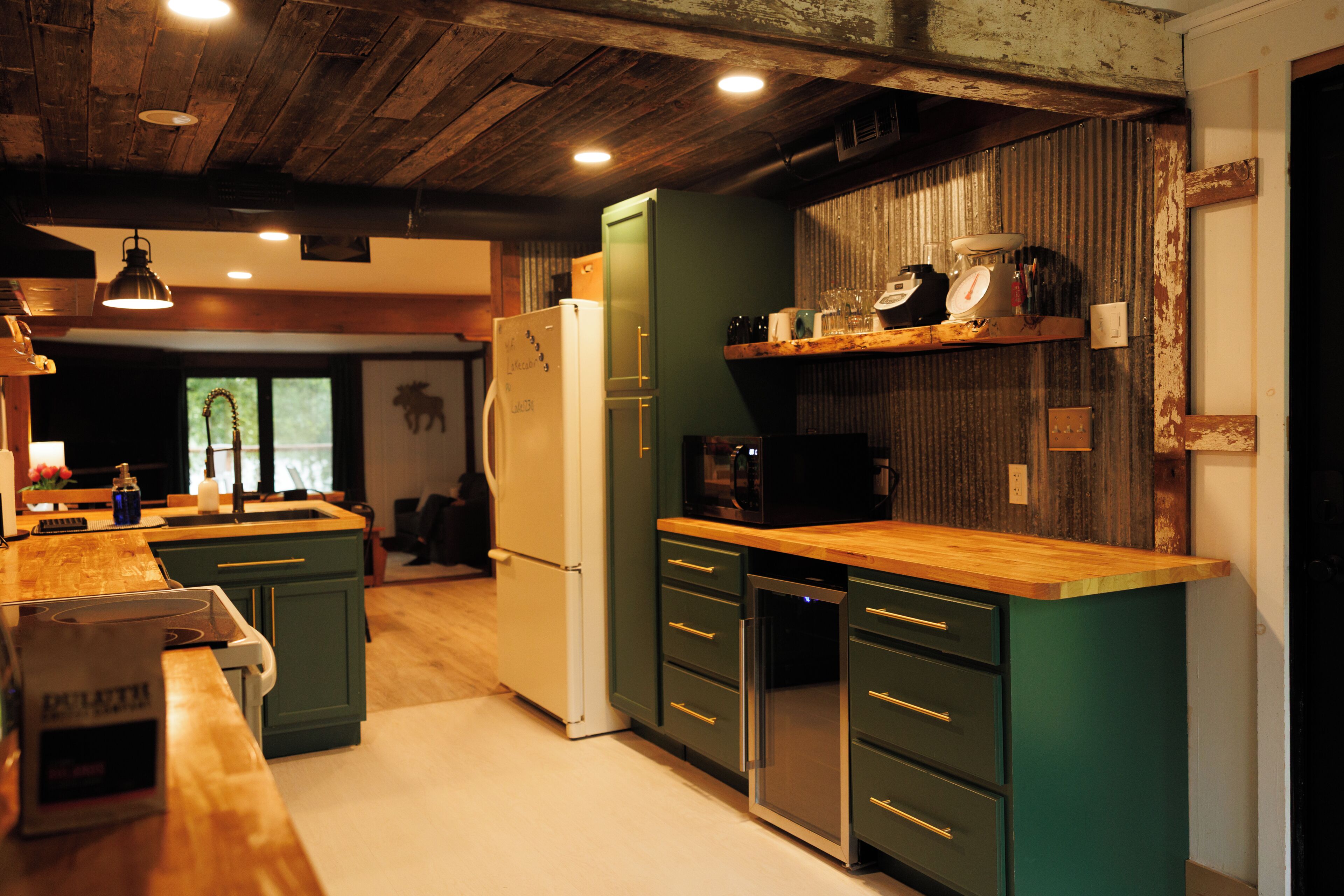 A modern kitchen with wooden countertops, a built-in oven, and a refrigerator.