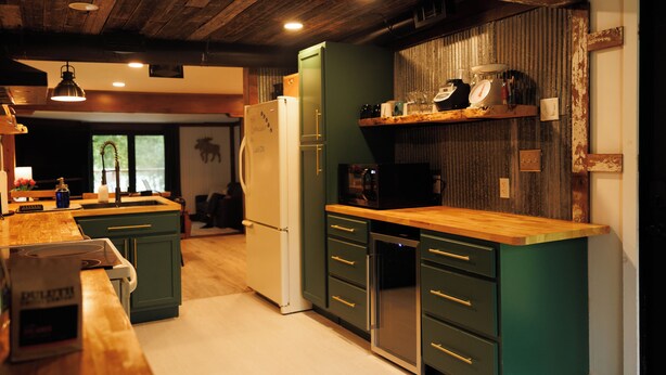 A modern kitchen with wooden countertops, a built-in oven, and a refrigerator. - Lakefront Cabin Near Duluth (Duluth)
