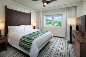 A hotel room with a bed, a television, a window with a view, a ceiling fan, and a nightstand. - 2 Bedroom Villa at Marriott Kaua'i Lagoons (Lihue)