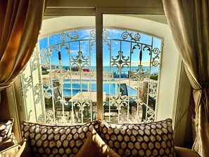 A room with a view of a pool and a beach. - Luxury Apartment - Pool & Ocean Right at Your Doorstep (IPTV, High-Speed Wi-Fi) (Tiguert)