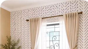 A bedroom with a bed, nightstand, and a window with curtains. - Cozy 3-bedroom house in peaceful Kingston with AC comfort (Kingston)