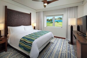 A hotel room with a bed, a television, a window with a view, and a ceiling fan. - 3 Bedroom Villa at Marriott Kaua'i Lagoons (Lihue)