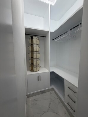 A walk-in closet with a hanging organizer, open shelving, and drawers. - Lovely 2-bedroom condo with AC in Nueva Nagua (Nagua)