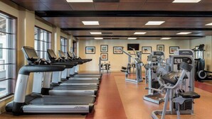 A gym with treadmills, weight machines, and exercise mats. - Studio Villa at Lakeshore Reserve w/ Amenities (Orlando)