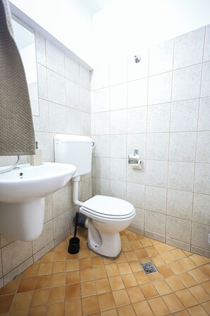 A bathroom with a toilet, sink, and a shower area. - Central PENTHOUSE Unirii - FREE
PARKING (București)