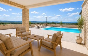 A rooftop terrace with a pool, lounge chairs, and a view of the landscape. - Amazing home in Kolan with sauna (Kolan)