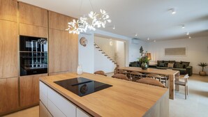 A modern kitchen with a central island, wooden cabinetry, and built-in Bosch appliances. - Amazing home in Kolan (Kolan)