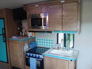 A compact kitchen with a microwave, stove, and sink. - Ponds view
Acadia National Park (Tremont)
